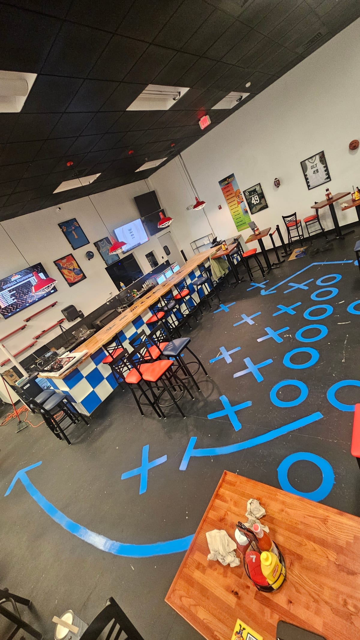 Crazy Legs CLT Restaurant interior with TVs and happy customers